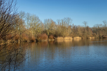 Obraz premium View of the manmade Gaverplas (Gaver Lake) in the Gavers Recreational Domain, near Geraardsbergen in East Flanders, Belgium. The lake is part of a popular public recreation area. Copy space.