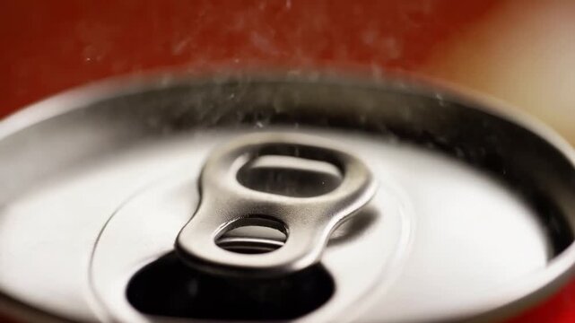 Opening soda can with fizz and bubble action in slow motion sequence