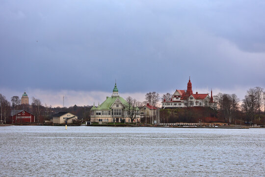 Historic waterfront buildings on Valkosaari and Luoto islands in Helsinki harbour, Finland; iconic buildings with green and red roofing, Baltic Sea archipelago, Gulf of Finland