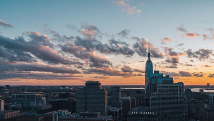 Fototapeta premium Downtown skyline sunset with dramatic clouds and modern skyscraper spire