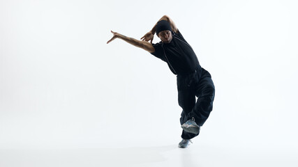 Male dancer performing dynamic jump in studio space. Concept of active lifestyle branding, sports motivation campaigns, movement based advertising and modern fitness promotion visuals.