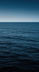 Fototapeta premium A vast expanse of dark blue oceanic water showing gentle waves reflecting the bright sky. The deep, rich color suggests purity and endless natural power ,ripple ,global ,aqua