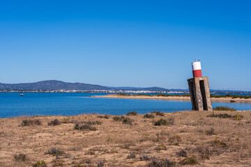 Lighthouse on the Algarve coast near Faro, Portugal on Island of Ilha Deserta