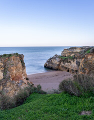 Praia de Dona Ana beach with emerald sea water and cliffs, Algarve, Portugal