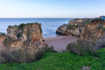 Praia de Dona Ana beach with emerald sea water and cliffs, Algarve, Portugal