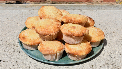 Plate of Lemon Streusel Muffins on Rustic Concrete Countertop