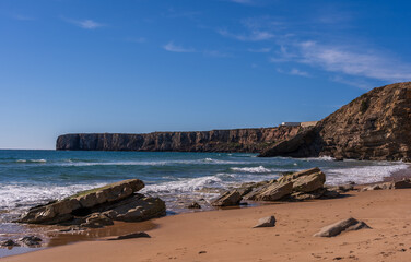 Scenic View Of Prainha das Po&ccedil;as beach and cliffs which is located in Sagres, Algarve Region of Portugal against Cloudy Sky. Located at the southwestern tip of mainland Europe.