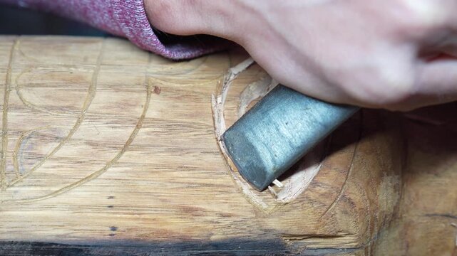 Close up Artisan carving a totem eye on wood