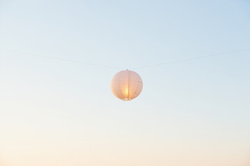 Lamp and lanterns floating in the sky at sunset