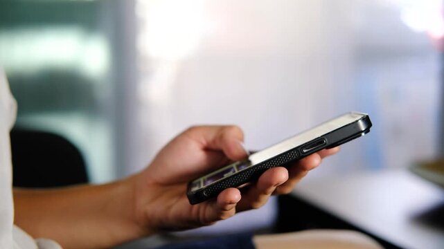 Close-Up Side View Hands Swiping and Scrolling Using Smartphone at Home.