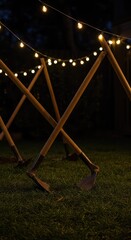 Garden tools, primarily hoes, resting under soft outdoor string lights late at night after a successful day of cultivation and tilling soil ,backyard ,rest ,nocturnal