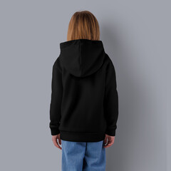 Template of black hoodie on girl in blue jeans, back view, isolated on background.