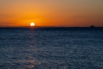 Obraz premium bright orange sky over The Isle of Wight Hampshire England and the sea at sunset