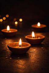 Earthen diyas with warm glow on dark background, candles in the dark
