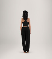 Template of black wide pants, yoga top, on woman, full height back view, isolated on background.