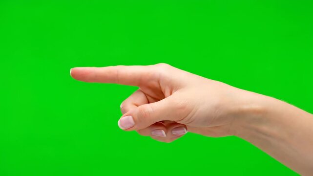 Hand pointing to the left against a green background.