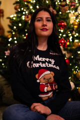 woman in pajamas near the christmas tree