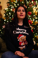 woman in pajamas near the christmas tree