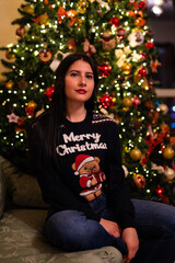 woman in pajamas near the christmas tree