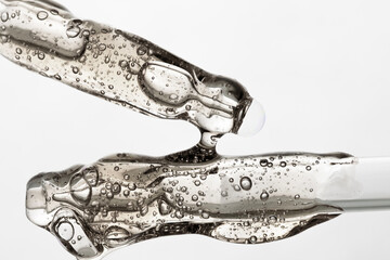 Pipettes with hydrating serum and hyaluronic acid, close-up. Beauty background with liquid product.