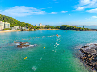Imagem a&eacute;rea da praia da costa em Vila Velha com o morro do Moreno ao fundo durante um evento esportivo de nata&ccedil;&atilde;o. Esporte aqu&aacute;tico no litoral do Esp&iacute;rito Santo.