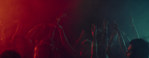 Abstract motion of dancing hands in colorful light haze. Concept of sensory overload, emotional flow, nightlife abstraction, music driven movement and New Year club experience. Banner