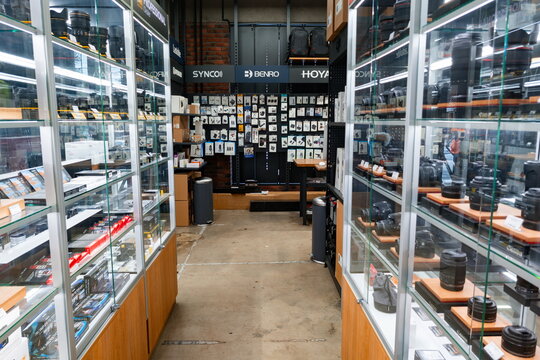 Camera equipment store filled with lenses and accessories located in a vibrant shopping area
