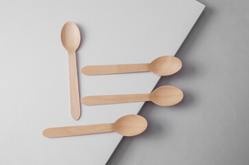 Wooden eco-friendly spoons on a light background