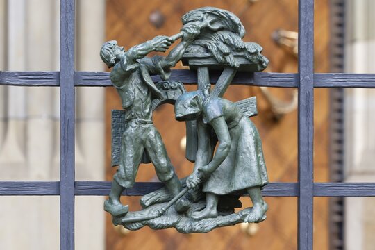 Prague castle, Gothic Metropolitan Cathedral of Saints Vitus, Wenceslas and Adalbert, Decorative figure of daily life scene on a fence, Prague, Czech Republic