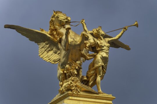 Column with the group of figures Fama of War on the Pont Alexandre III bridge over the Seine, Paris, France