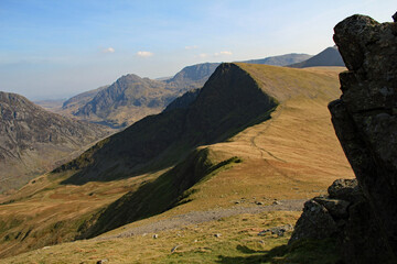 View down the Nant Francon valley in the Snowdonia Mountains national park and showing the dramatic scenery, namely from the left, Yr Ole Wen, Tryfan, and Foel Goch mountains and hills