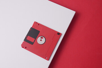 Red Retro plastic floppy disks on a white board