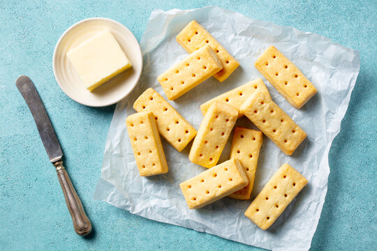 Traditional Scottish shortbread biscuits on a parchment paper. Blue background. Top view.