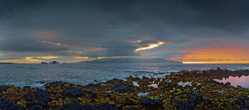 Extensive volcanic coastal landscape of Madalena at sunset with dynamic cloud formations, Madalena, Pico, Azores, Portugal
