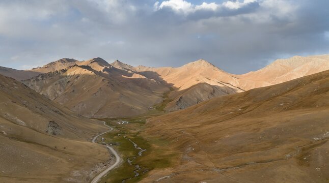 Aerial view of mountain valley with gravel road, Naryn region, Kyrgyzstan