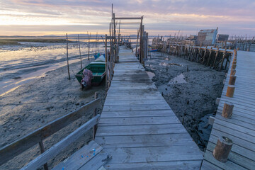 Carrasqueira palafitic port wooden pier at sunrise low tide