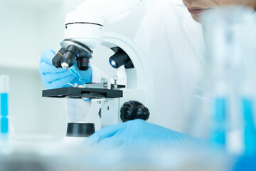 Scientist analyze biochemical samples in advanced scientific laboratory. Medical professional use microscope look microbiological developmental of viral. Biotechnology research in science lab.