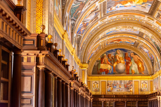 Vibrant Renaissance frescoes depicting Philosophy and the liberal arts cover the vaulted ceiling and walls of the Royal Library at El Escorial in Madrid, Spain