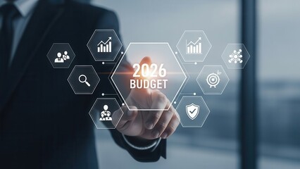 Businessman touching a futuristic digital screen interface for 2026 budget planning and financial strategy