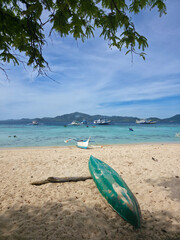 small local boats on turquoise tropical wave sea near philippines islands with beautiful sand beach on sunny day