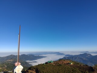 Misty mountain landscape with fog and dramatic sky