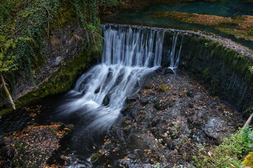 Waterfall on the river with reflection in water