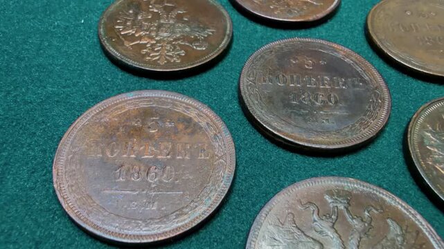 Close-up of vintage Russian Empire 5 kopecks coins on a green surface. Alexander I and Nicholas I.