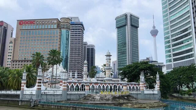 Malaysia - June 10, 2025: Panoramic view of the Masjid Jamek Sultan Abdul Samad Mosque and the confluence of the Klang and Gombak rivers with skyscrapers in the capital city of Kuala Lumpur.4К