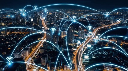 A city skyline at night with digital connectivity symbols representing wireless networks.