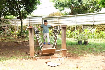 Child walking carefully across a wooden bridge in a green park, symbolizing mindful steps, balance, and sustainable living values.