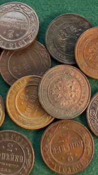 A collection of vintage Russian 2 kopecks coins with varying patinas on a green surface.