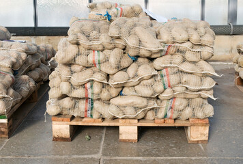 Bags of potatoes on a pallet in wholesale market