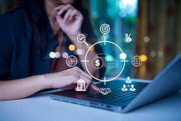Business professional using laptop with financial icons showing investment, banking, payments, ROI and global economy, representing fintech strategy, digital finance, data driven decisions