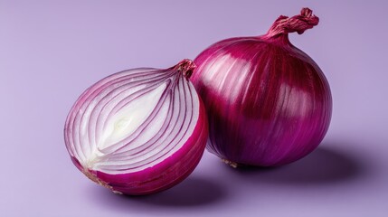 A vibrant display of a whole red onion and a sliced half, showcasing its rich color and layered texture against a soft purple background.